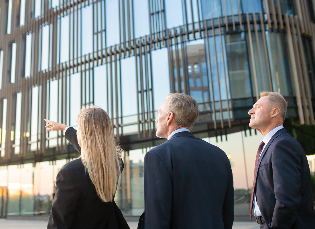 Business Insurance - Business Colleagues Pointing and Looking at an Office Building for a Potential Real Estate Property Opportunity